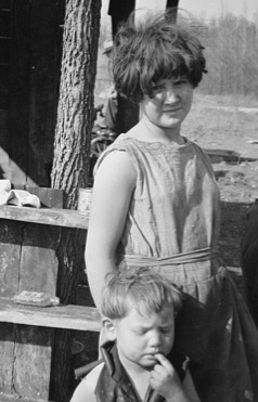 Girl dressed in a flour sack, early 1930's (Library of Congress).