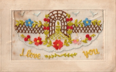 Early 20th century silk embroidered postcard with the text "I love you".