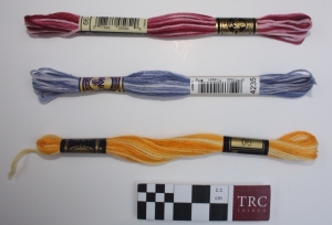 Three skeins of shaded yarns.