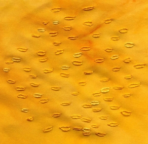 Hand embroidered powdering of stitches on a silk background.