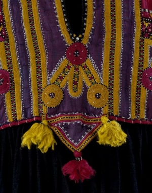 Detail of a dress, Pakistan, 19th century, with triangular amuletic shape hanging down from the waistband.
