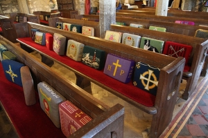 Rows of hassocks on church pews, Cornwall, Britain.