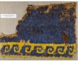 Fragment from a cloak, made of woven cotton with applied feathers. Peru, c. 900-1476.