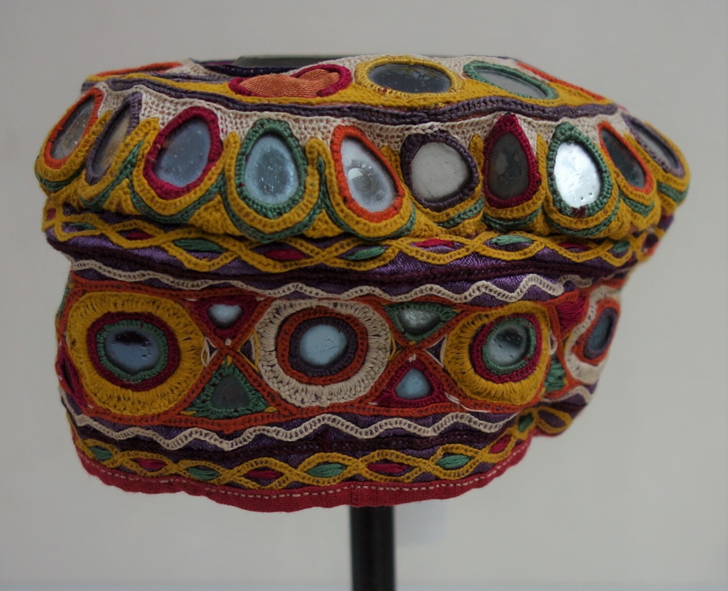 Small cap with a large crown and wide brim. The cap is decorated with shisha-work. India, Gujarat/Kutch, 20th century (TRC 1997.0147).