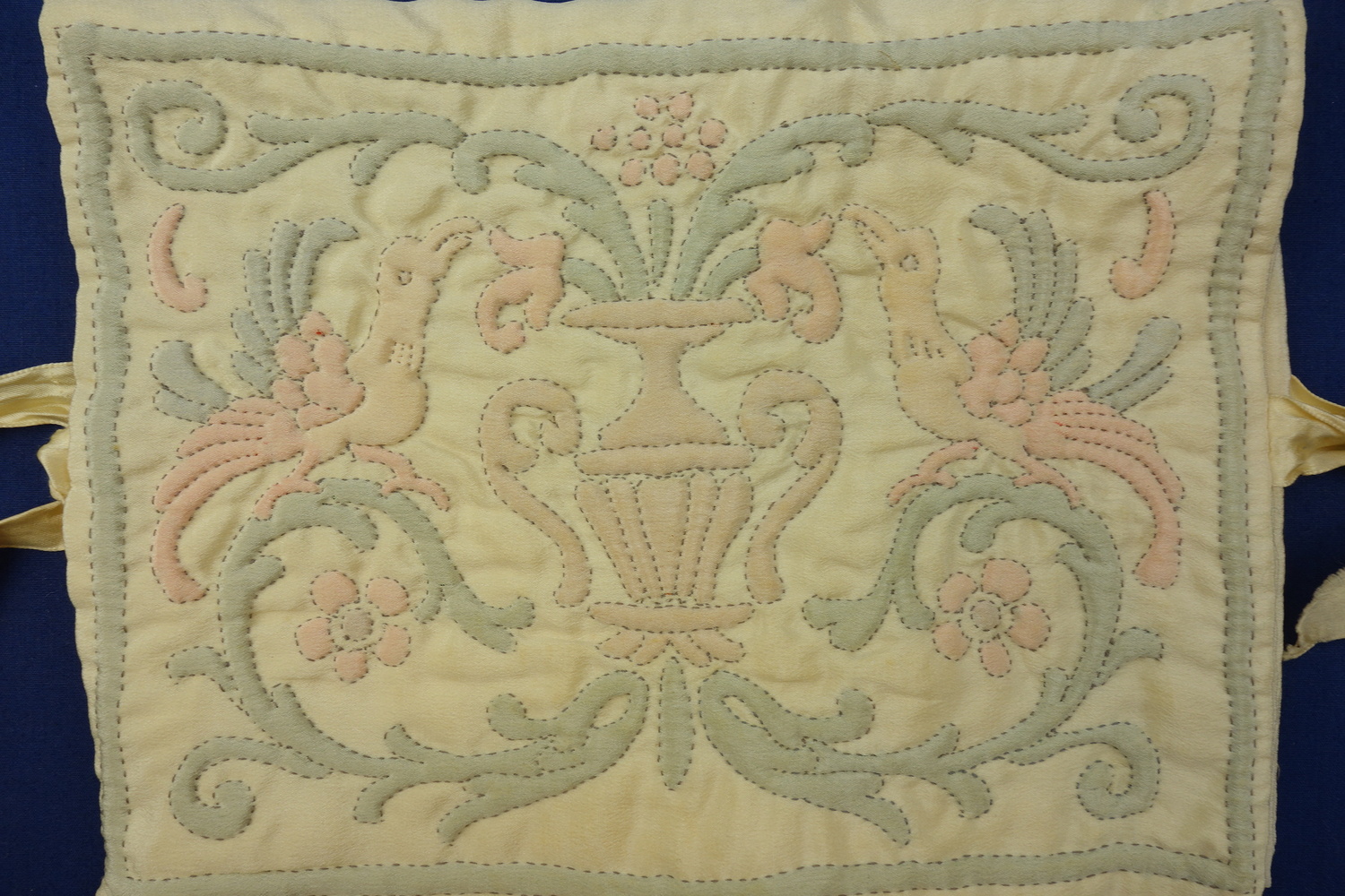 Detail of a cover decorated with padded shadow work, the Netherlands, early 20th century (TRC 2016.2372).