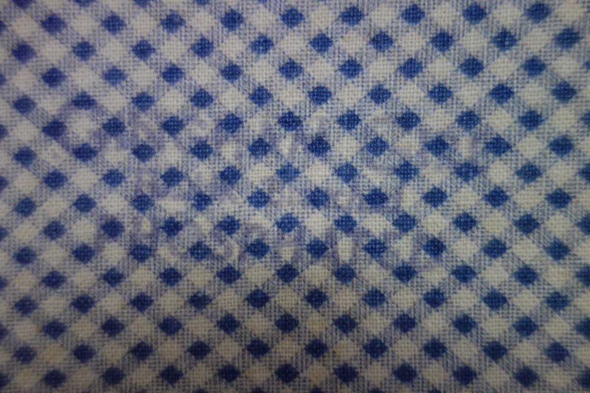 Detail of printed Gingham Girl cloth, USA, c. 1925. It contains a printed text: "GINGHAM GIRL flour bleached phosphated" (TRC 2018.0001). Donation by Gloria Nixon.