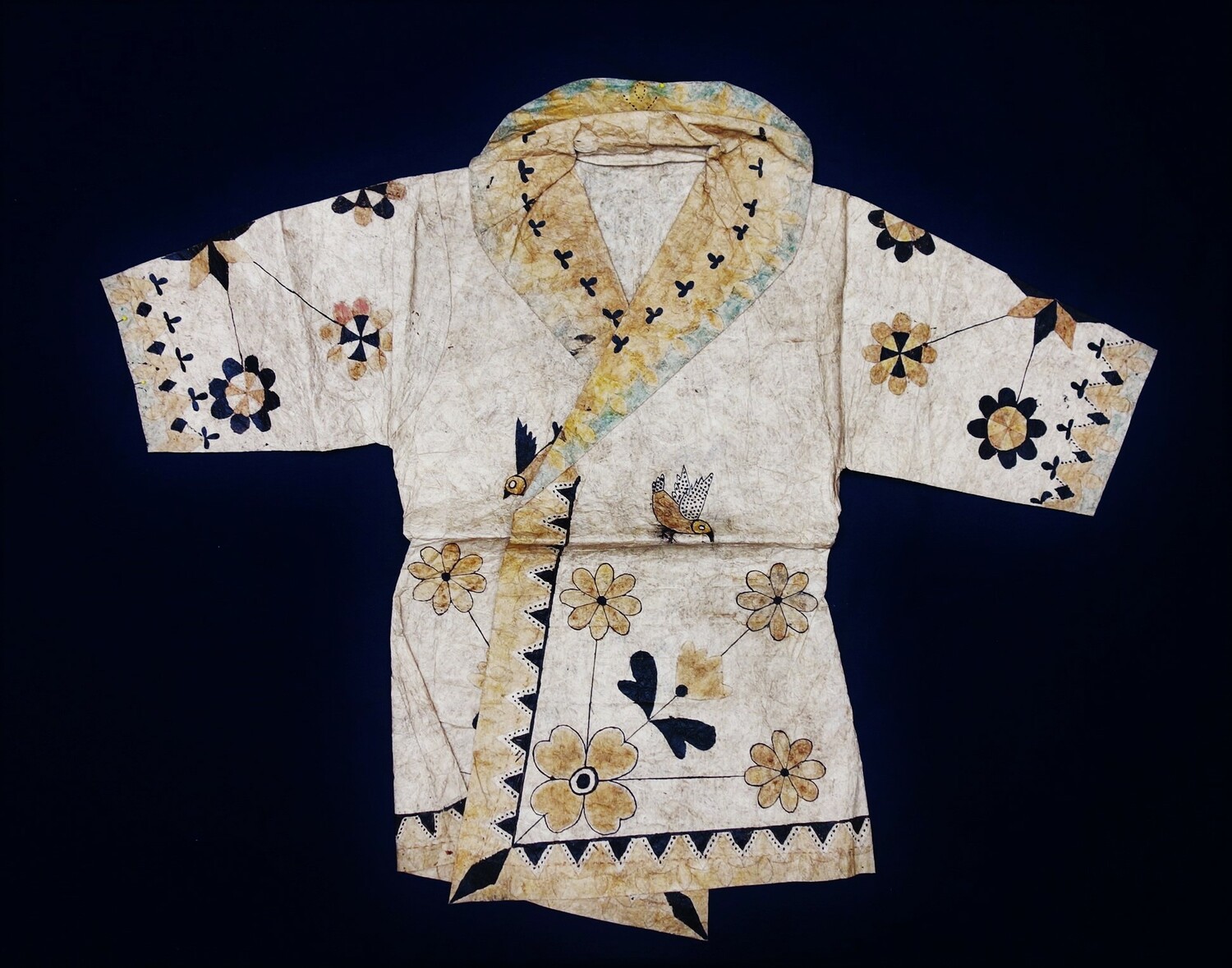Woman's blouse made of bark bast and hand painted with a design of rosettes and quatrefoils, as well as stylised birds, butterflies and flowers. East Sulawesi, Indonesia (TRC 2018.0042).