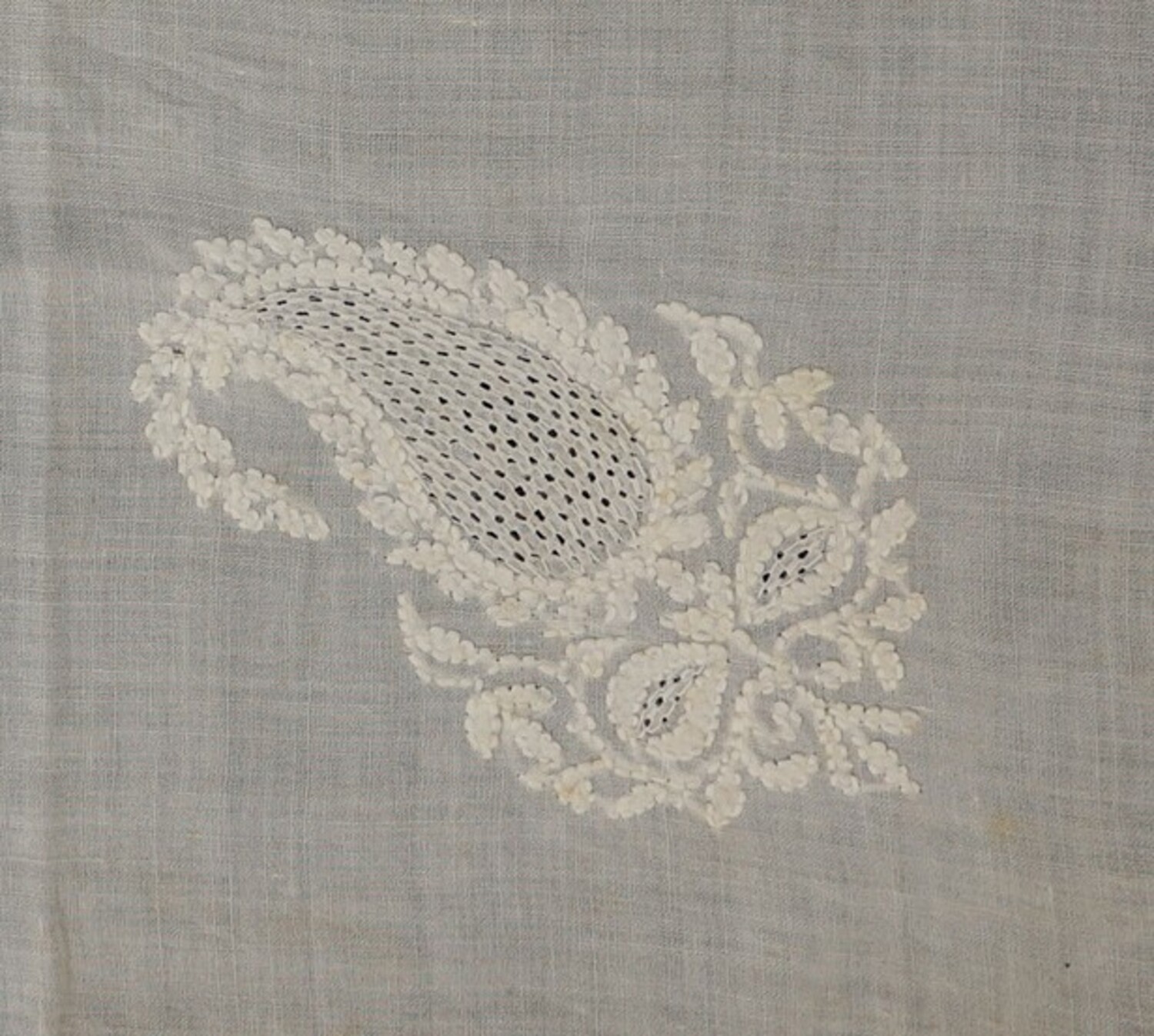 Detail of a handkerchief of chikan shadow work from Lucknow, northern India, mid-20th century (TRC 2018.2869). The rows of herringbone stitches worked on the reverse side of the cloth, create the appearance of parallel rows of back stitches on the front side.