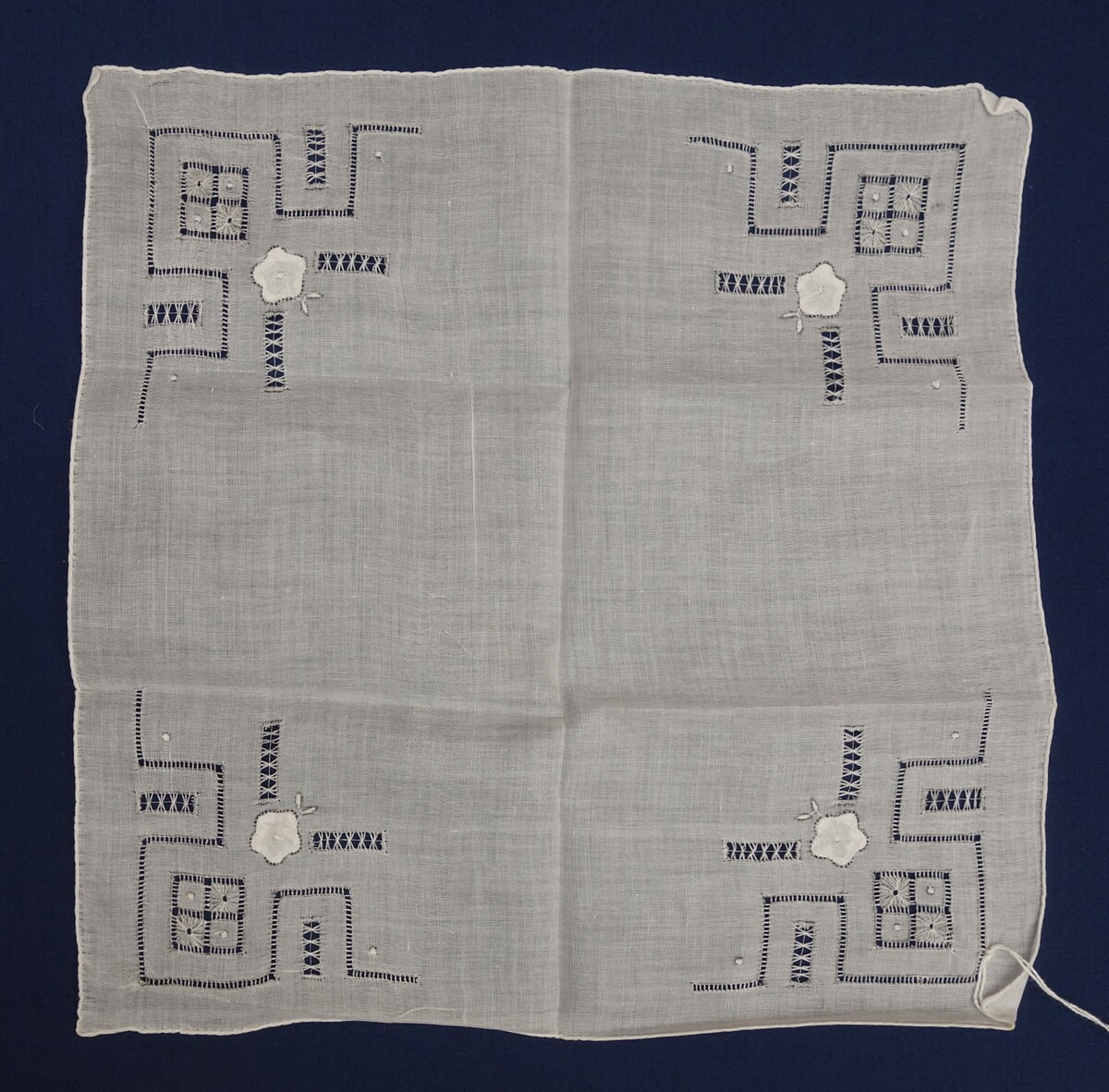 Detail of a handkerchief decorated with a combination of drawn thread work, ‘positive’ embroidery and shadow work appliqué, 1930s, the Netherlands (TRC 2018.3003).