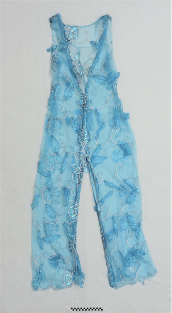 Turquoise net drag costume, with silver coloured braids and hand applied turquoise sequins, donated by Jennifer Hopelezz. Early 21st century, Netherlands (TRC 2019.1622).