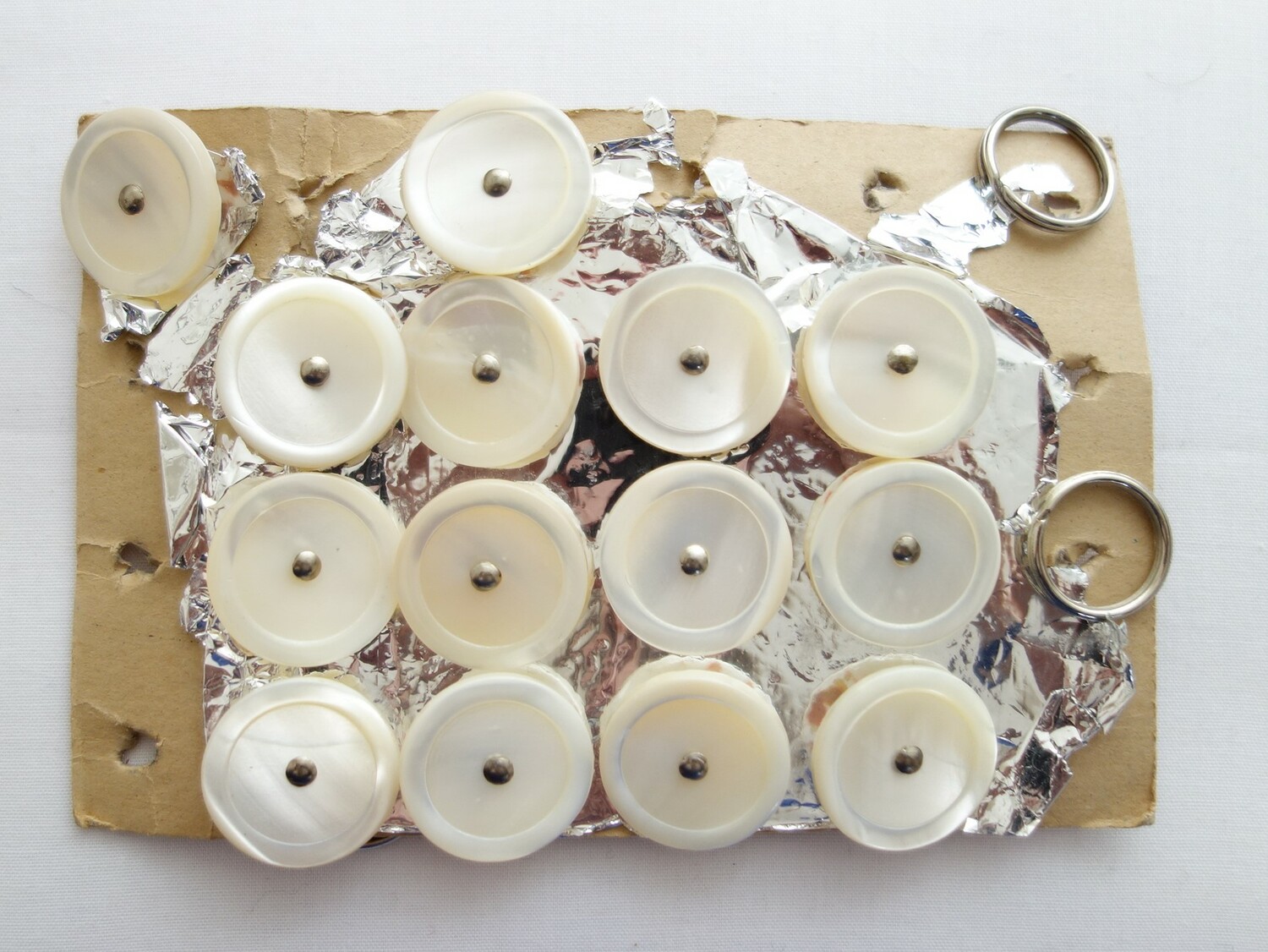 Early 20th century sheet of mother-of-pearl buttons with metal shanks, Europe (TRC 2020.2446).