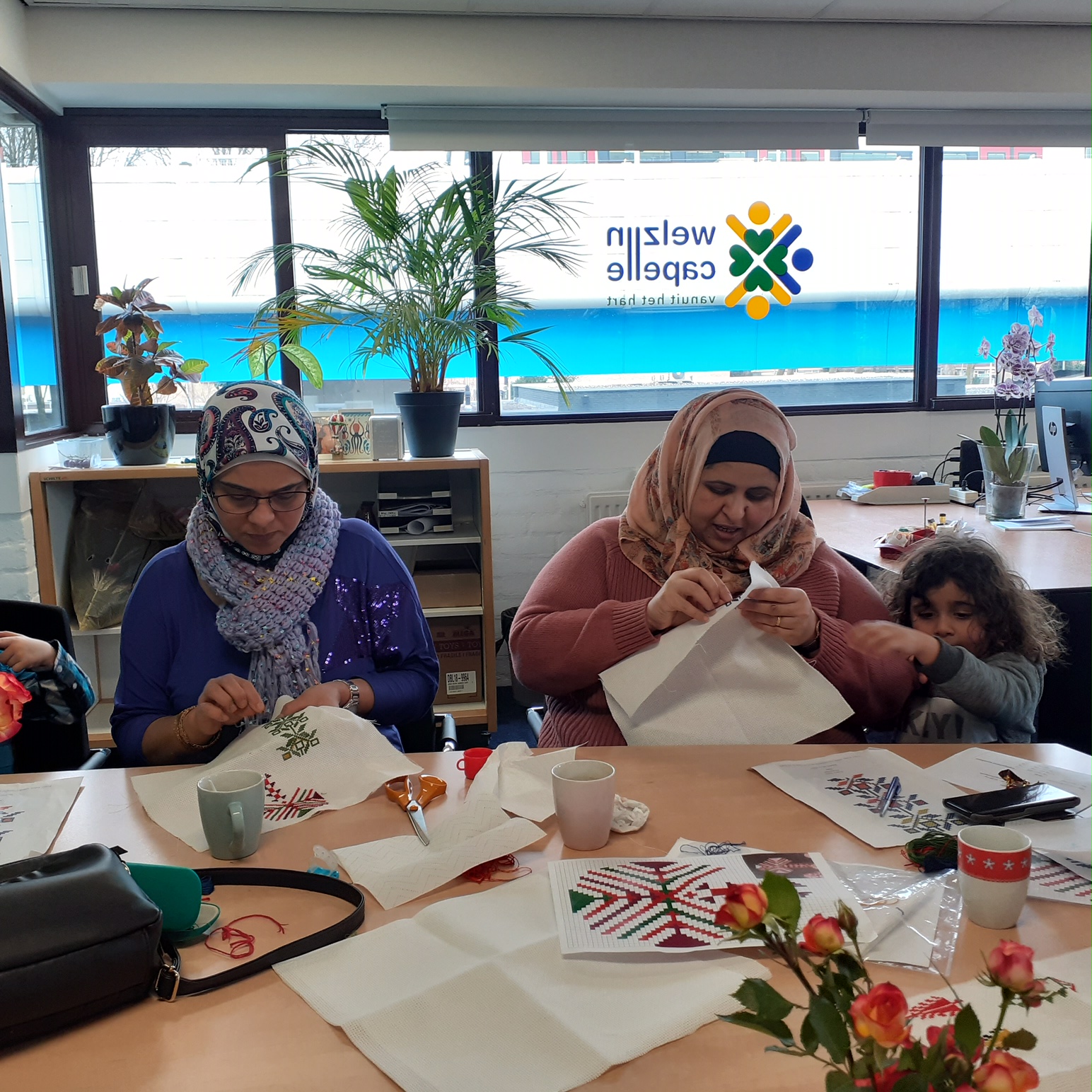 Arab women, and a girl, practising Middle Eastern embroidery.
