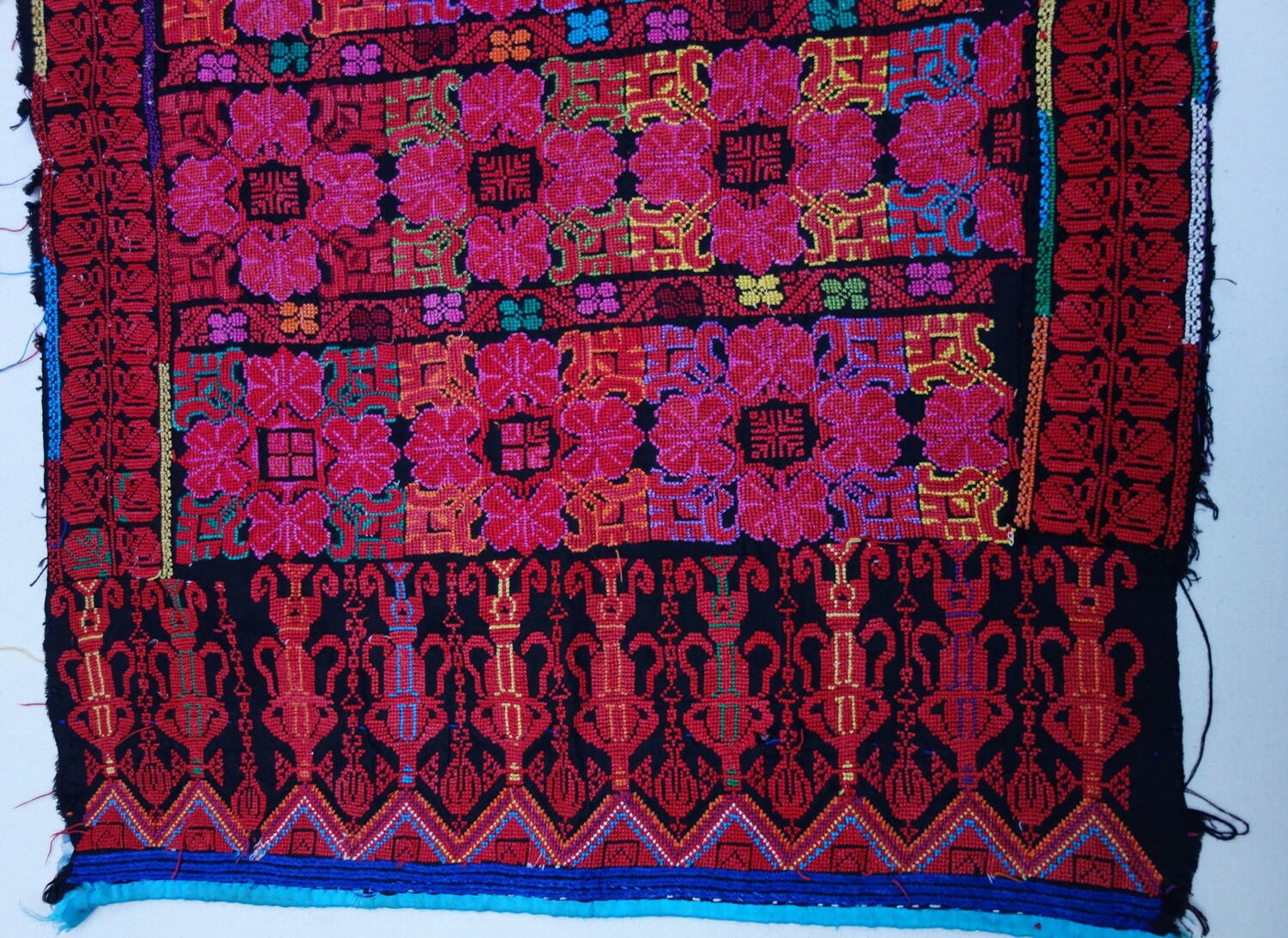 Detail of a back panel of a Palestinain dress with Chinese-style embroidered motifs, mid-20th century (TRC 2021.3349c).