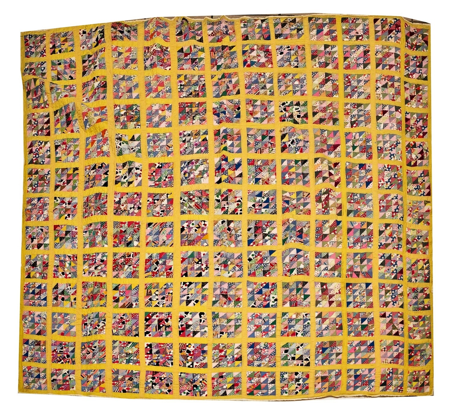 A 1930-40’s mosaic quilt comprised of 169 5 inch blocks each containing 32 triangles of a myriad scraps of fabric, including some feedsacks along with multiple others (TRC 2022.1153).
