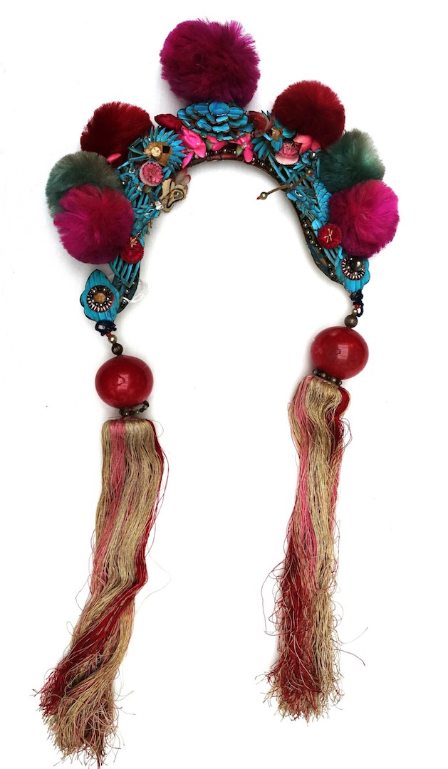 Early 20th century Chinese headdress, with silk pompoms, glass beads and tassels, as well as floral and insect motifs, some in silk, others in kingfisher feathers (TRC 2023.2518).