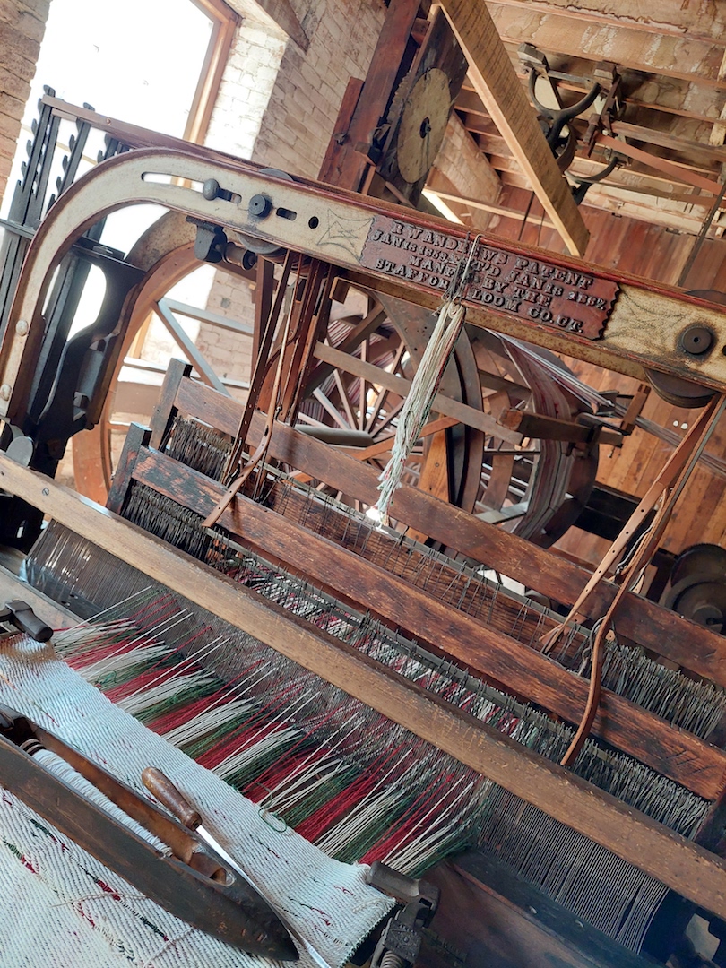 Weaving a blanket on a loom at Watkins Mill. Photo by Shelley Anderson.