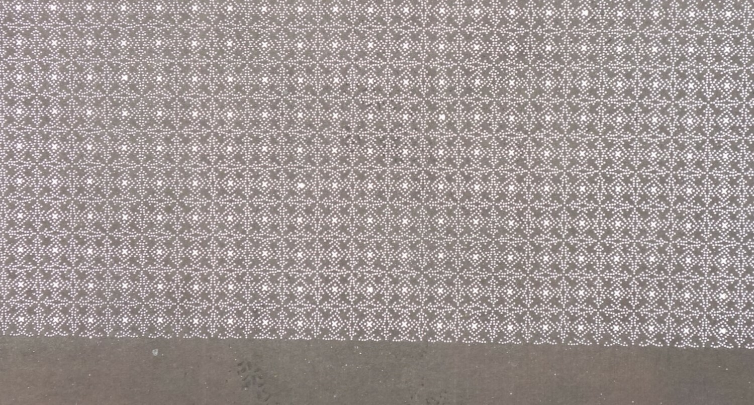 Detail of mulberyy paper stencil with a small, repeating pattern of a square trellis work enclosing quatrefoils and X-shapes, all worked in tiny dots. Japan, 20th century (TRC 2024.2016).