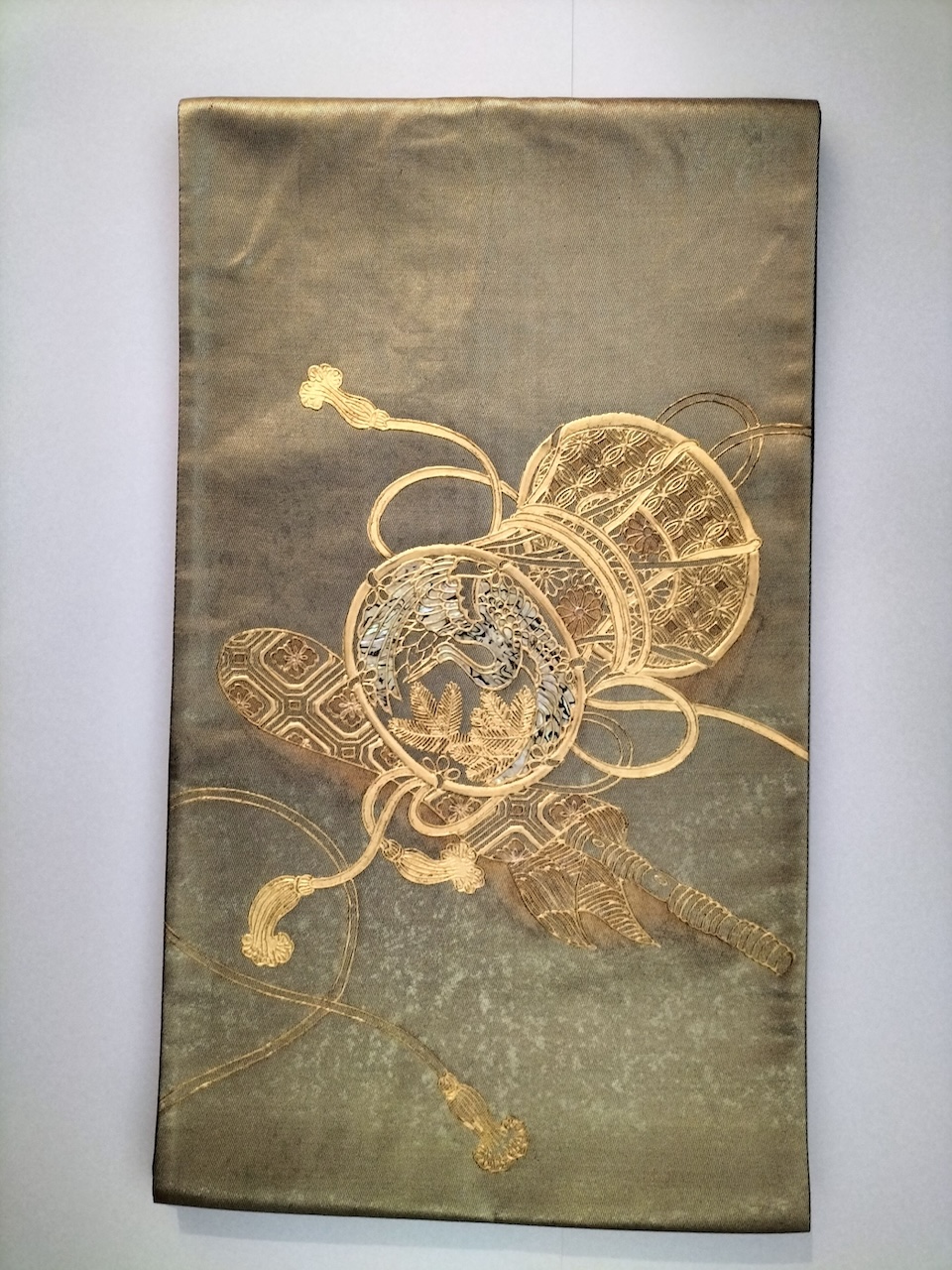 Fig. 5. Part of an obi with a hikibaku design of a drum and flutes in bags.