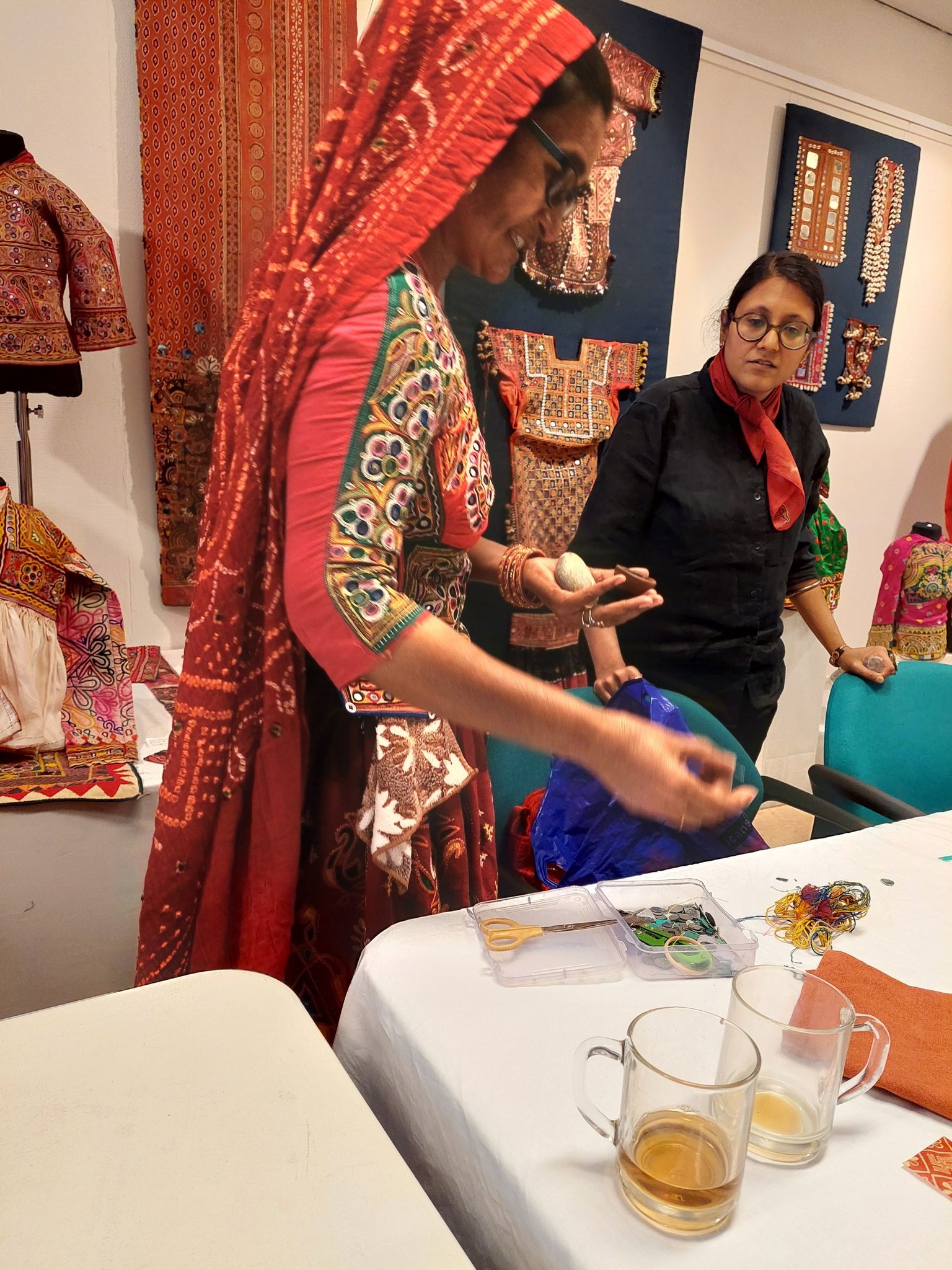 Master shisha embroiderer Geetaben Meriya explains how a small rock was used to grind powder, in order make  paint to draw embroidery designs on fabric. Photo by Shelley Anderson