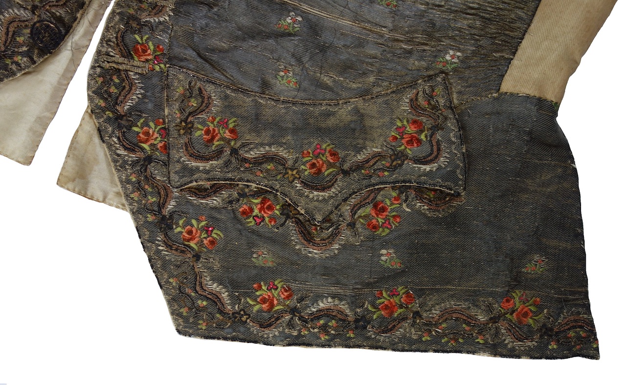 Decorated pockets and front of the man's waistcoat (TRC 2020.0879).