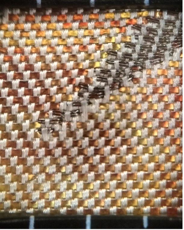 Fig. 4. The structure of a hikibaku weave. The weft threads are in silver-grey, the hikibaku strips are in yellow-orange-brown, untwisted, and the warp threads are in a cream colour,