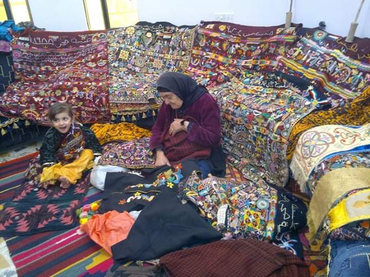 Elderly woman from Qaraqosh explaining the patterns on a charuga. 