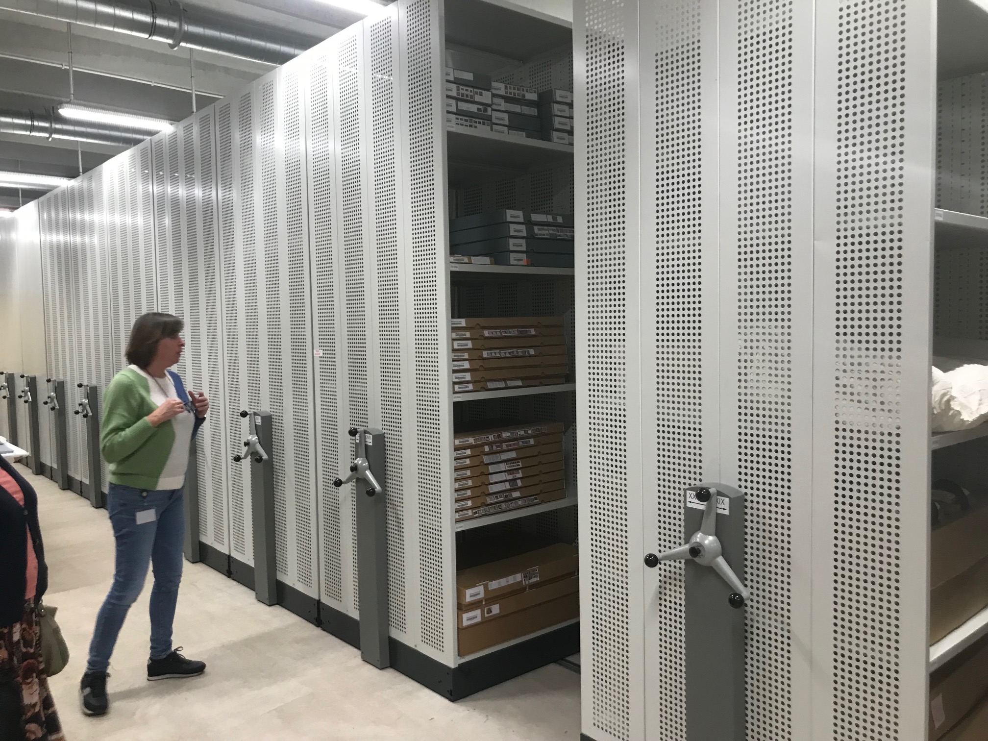 Greet Verschatse at Trezoor, Kortrijk, showing part of the huge depot of local cultural heritage. Photograph by Willem Vogelsang.