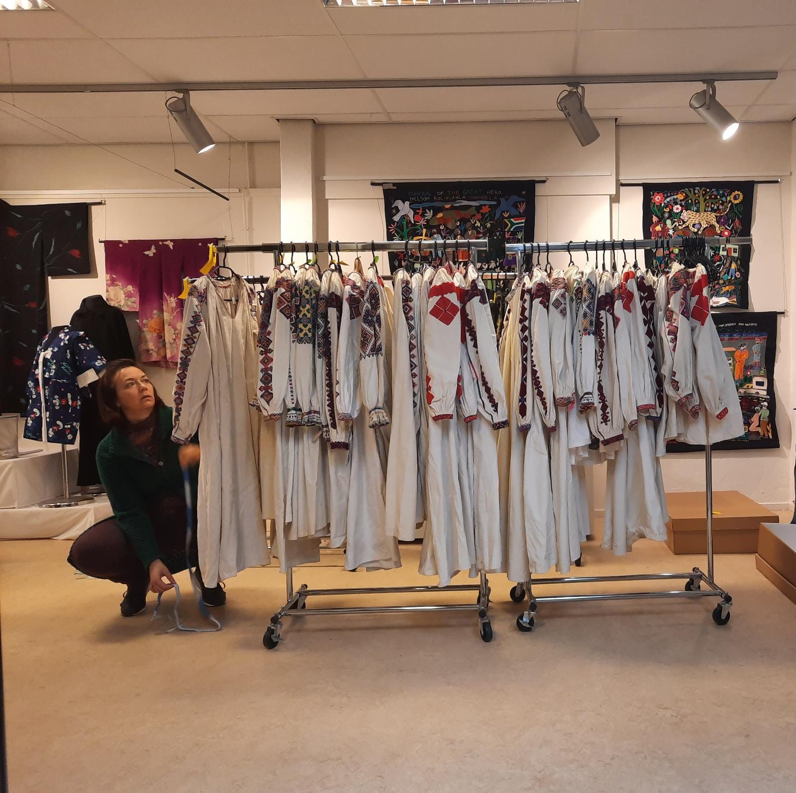 Dresses from the Amsel collection, 21 February 2022, together with one of the TRC volunteers. Photograph: Augusta de Gunzbourg.