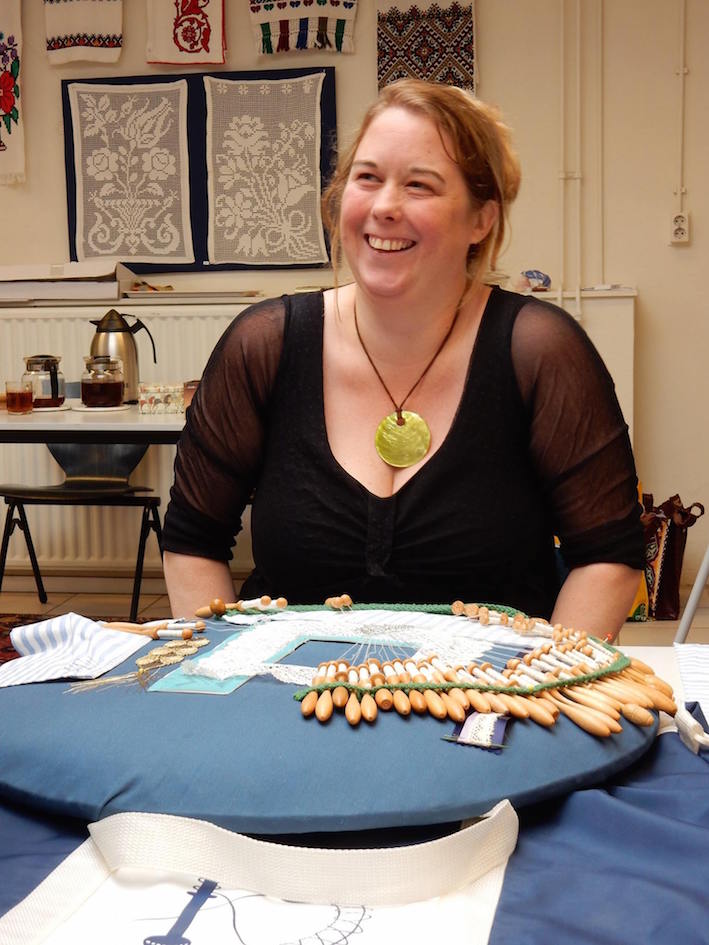 Marieke Roozeboom, one of the course participants, behind a bobbin lace pillow.