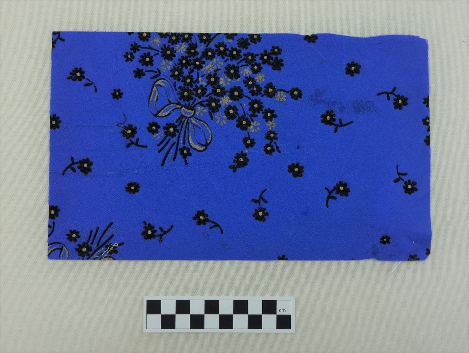 Sample of cloth with a floral design in flock, late 20th century (TRC 2017.0519).
