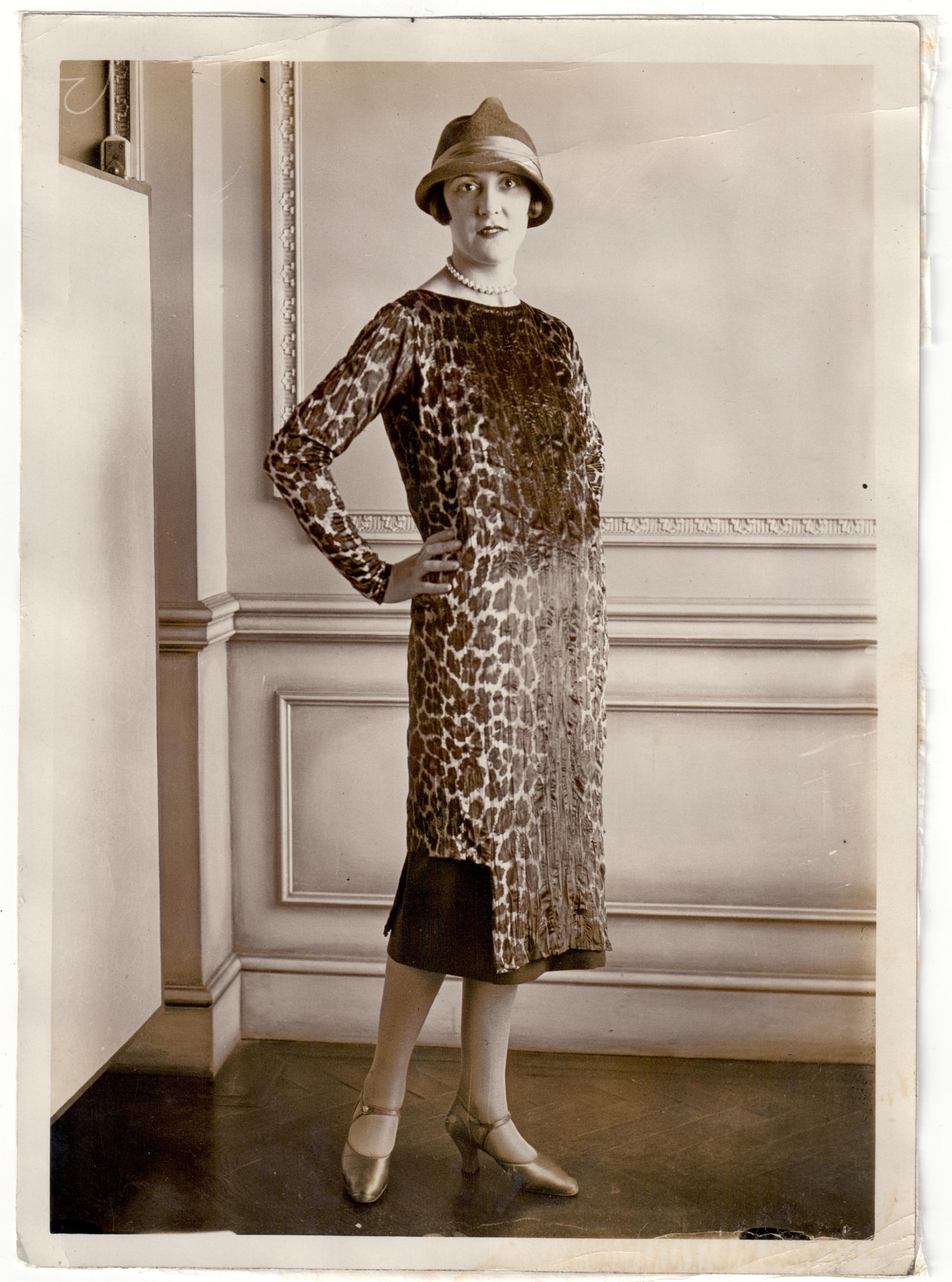 Photograph from the 1920s showing a professional model wearing a velvet dress with a design of leopard skin spots (TRC 2018.3137).
