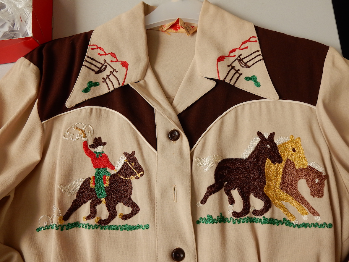 Detail of a cowgirl shirt embroidered with horse rider. TRC 2017.0267