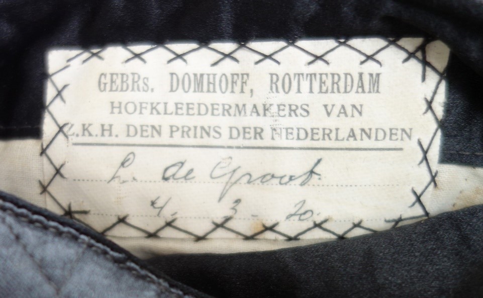 Tailor's label of coat (TRC 2018.2133a, above).