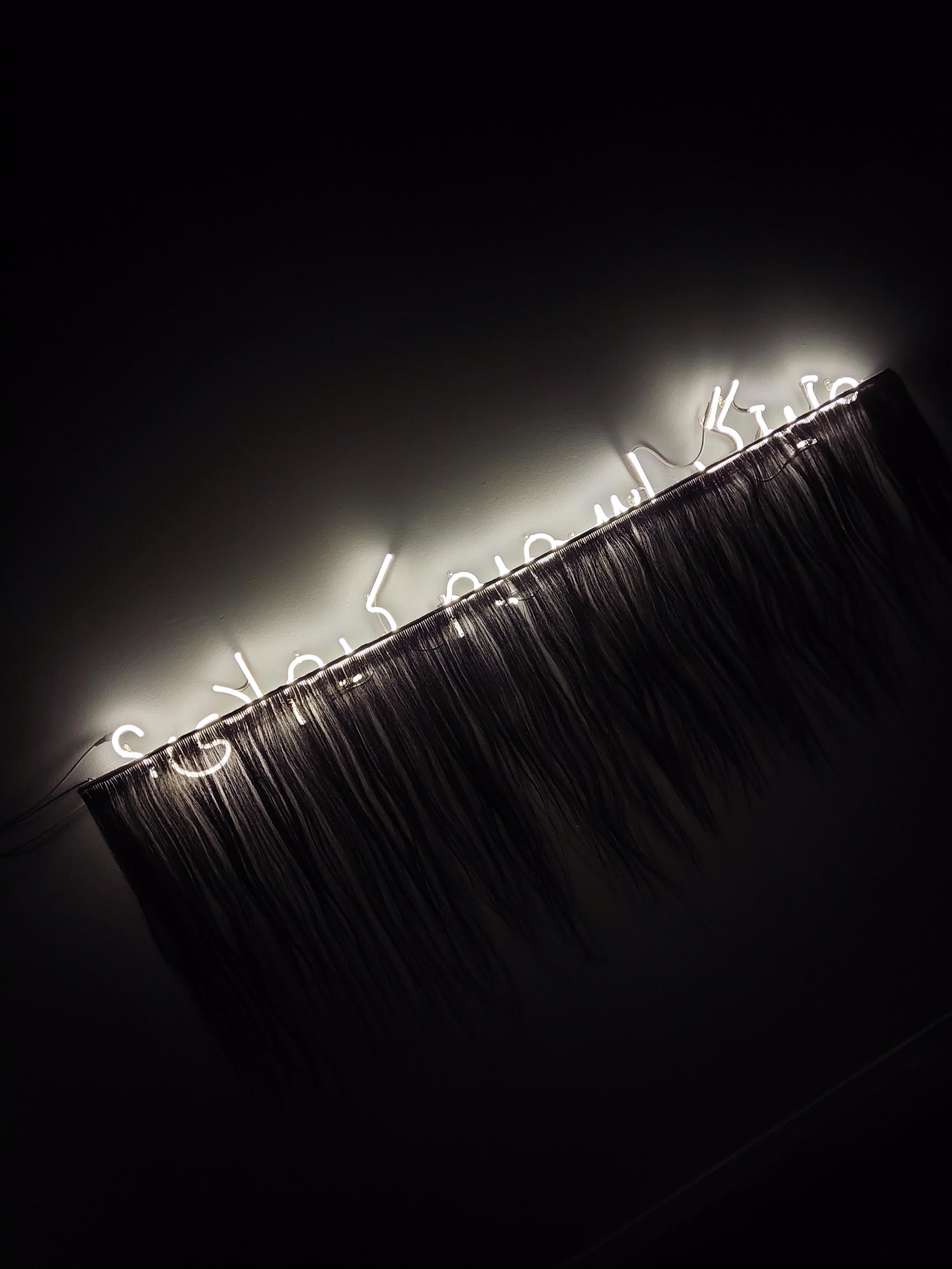 “What was my name?” in neon light, written in Arabic script, in Uzbek language. Exhibition “18,000 Worlds” by Saodat Ismailova, on until 4 June at the EYE Film Museum, Amsterdam.